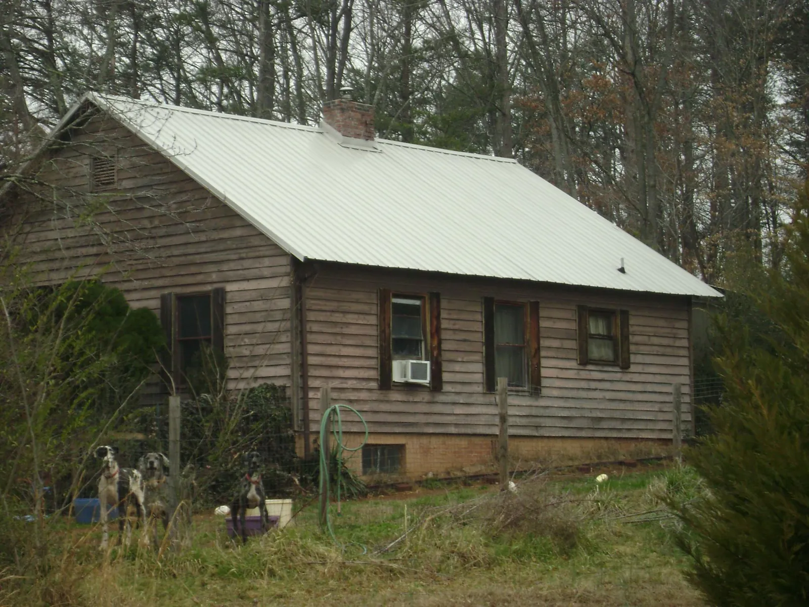 White metal roof on an old wood sided farmhouse, from a Metal Roof Installation job in Rayville